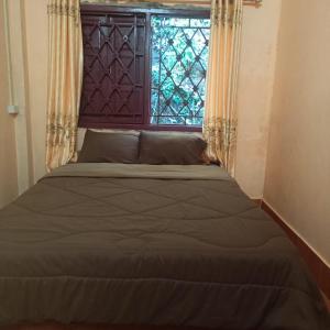 Cama o camas de una habitación en Phonephithak Guesthouse