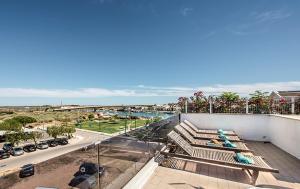 a balcony of a building with a view of a beach at Exclusive new apartment in Tavira in Tavira