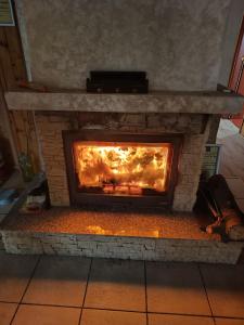 a brick fireplace with a fire in it at MAXX Lodge in Bacău