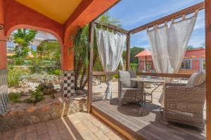 a wooden deck with a table and chairs on it at Villas D. Dinis - Charming Residence (adults only) in Lagos