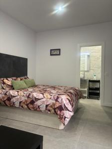 a bedroom with a bed in a white room at Estupendo piso a 5 min de la estación de Bus y Tren María Zambrano in Málaga