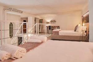 a bedroom with two beds and a fireplace at Milan Retreats Brera in Milan