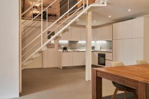 a kitchen and dining room with a staircase in a house at Milan Retreats Brera in Milan