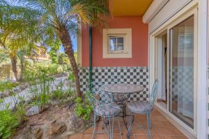 a table and chairs on the porch of a house at Villas D. Dinis - Charming Residence (adults only) in Lagos