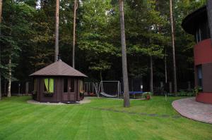 a small gazebo in a yard with a playground at Cozy house with sauna, pool and private garden in Rīga