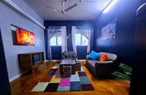 a living room with a couch and a tv at Zahra Homes in Mombasa