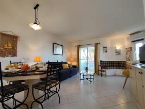a kitchen and living room with a table and chairs at Albufeira Balaia Golf Vilage 4 With Pool by Homing in Albufeira