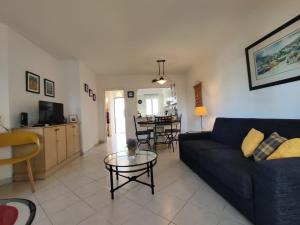 a living room with a couch and a table at Albufeira Balaia Golf Vilage 4 With Pool by Homing in Albufeira