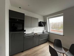 an empty kitchen with a sink and a window at Da Costa 12B in Leiden