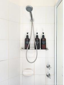 a shower with a shower head in a bathroom at Fremantle High Street Retreat in Fremantle