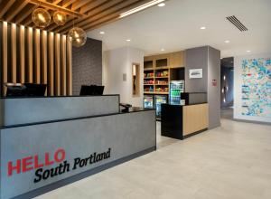 un vestíbulo de hotel con un mostrador de saludos al sur de Portland en TownePlace Suites Portland Airport ME en South Portland