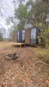 a tiny house sitting on top of a field at Hill Creek 3 Tiny House in Perwillowen