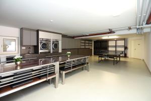 a large kitchen with a ping pong table in it at Villa Schmidt - Strandhaus direkt am Meer mit Sauna, Sport und Dünengarten IV in Warnemünde