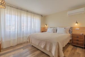 a bedroom with a large bed and a window at Villas D. Dinis - Charming Residence (adults only) in Lagos