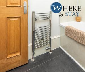 a bathroom with a towel rack next to a door at Lovely Aberdeen Apartment, Free Parking, River Side in Aberdeen