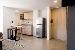 a kitchen with a refrigerator and a table in it at GURUS FR | Cómodo Elegante cerca Termales in Santa Rosa de Cabal