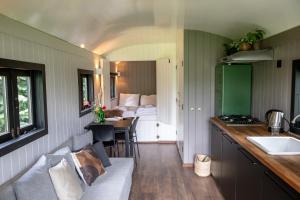 a tiny house with a kitchen and a living room at Camping de Vliert in Bunnik