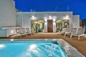 a swimming pool in the middle of a house at Maltese Luxury Villas - Sunset Infinity Pools, Indoor Heated Pools and More! in Mellieħa