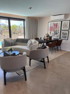 a living room with a couch and chairs and a table at Vergenoegd Löw Boutique Hotel & Spa in Somerset West