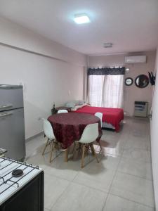a kitchen with a table and a bed in a room at Monoambiente Confortable Tucuman in San Miguel de Tucumán