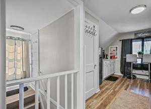a hallway with white walls and a staircase in a house at St Paul Fry Street Den Tower Suite #3 in Saint Paul