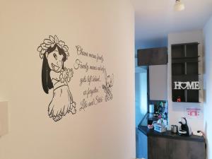 a drawing of a woman on a wall in a kitchen at Residenze Ohana in Fiumicino