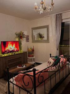 a bedroom with a bed and a tv and a fireplace at Apartmani Sollei in Petrcane