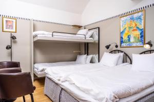 two beds in a room with two bunk beds at STF Långholmen Hostel in Stockholm