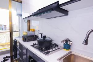 a kitchen with a stove with a pot on it at The Gold Park 2 bedroom Kilimani in Nairobi