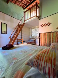 a bedroom with a large bed and a staircase at Lagamar Ecohotel in Cananéia