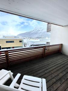 a balcony with chairs and a view of a mountain at Cozy apartment in St. Moritz in St. Moritz
