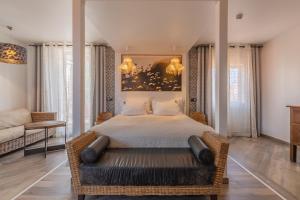 a bedroom with a large bed and a couch at Villas D. Dinis - Charming Residence (adults only) in Lagos