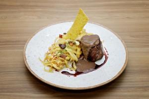 a plate of food with pasta and a tortilla chip at Hotel Flor Da Chapada in Itaberaba