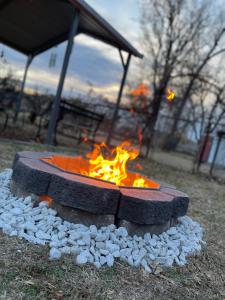 a fire pit in a park with rocks around it at Modern Comforts/7minTo Downtown in Oklahoma City