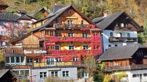 a building with flowers on the side of it at dachstein view in Bad Goisern
