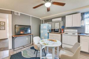 a kitchen with a table and chairs and a refrigerator at Fort Walton Beach Studio Shared Pool and Beach Bar! in Fort Walton Beach