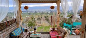 a porch with chairs and a view of a valley at Tiny Home Glamping en Latacunga in Latacunga