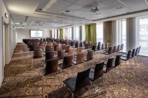 a conference room with chairs and a projection screen at Clarion Congress Hotel Bratislava in Bratislava