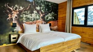 a bedroom with a bed with deer heads on the wall at Alpen Lodge Riezlern in Riezlern