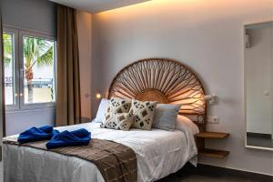 a bedroom with a large bed and a window at Amor A Mar Dolphin in Puerto del Carmen