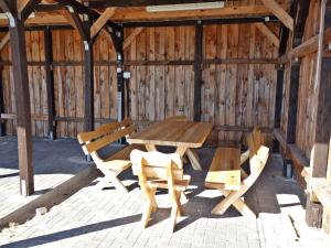una mesa de madera y sillas en un granero de madera en Feldstrasse 3 b en Zempin