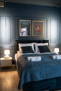 a bedroom with a large bed with two pillows at Apartamenty Rynek 12 in Tarnów