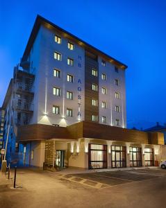 a large building with a clock on the front of it at HB Aosta Hotel & Balcony SPA in Aosta