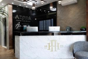 a reception desk with two laptops on top of it at Adria Premium Hotel in Guarapuava