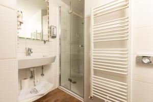 a bathroom with a shower and a sink at Hotel Landgasthof Gappen in Kramsach