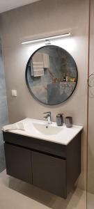 a bathroom with a sink and a mirror at La Maisonette, Florina Center in Florina