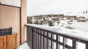 a balcony with a view of a town in the snow at LE VERNON 1027 Appt premium 4 pers in Chamrousse