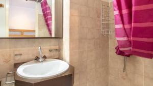 a bathroom with a sink and a pink shower curtain at LE VERNON 1027 Appt premium 4 pers in Chamrousse