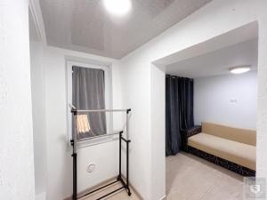 a small room with a bed and a window at Renthouse Apartments City Gates #4 in Chişinău