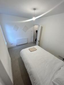 a small room with a white bed in it at Canvas House in Carlisle